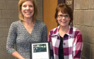 Stacey Jenkins (left) accepting award from DCSWCD Board President Laura Zanmiller (right)