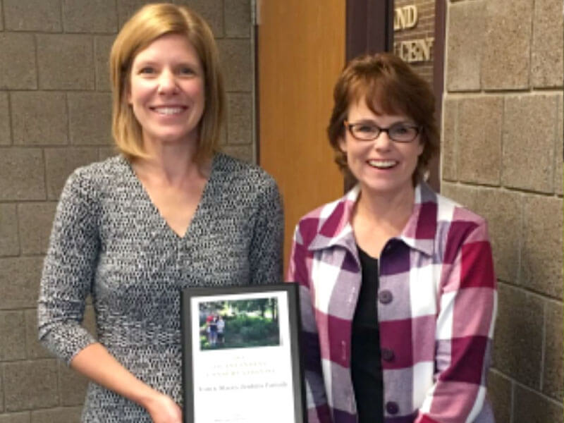 Stacey Jenkins (left) accepting award from DCSWCD Board President Laura Zanmiller (right)