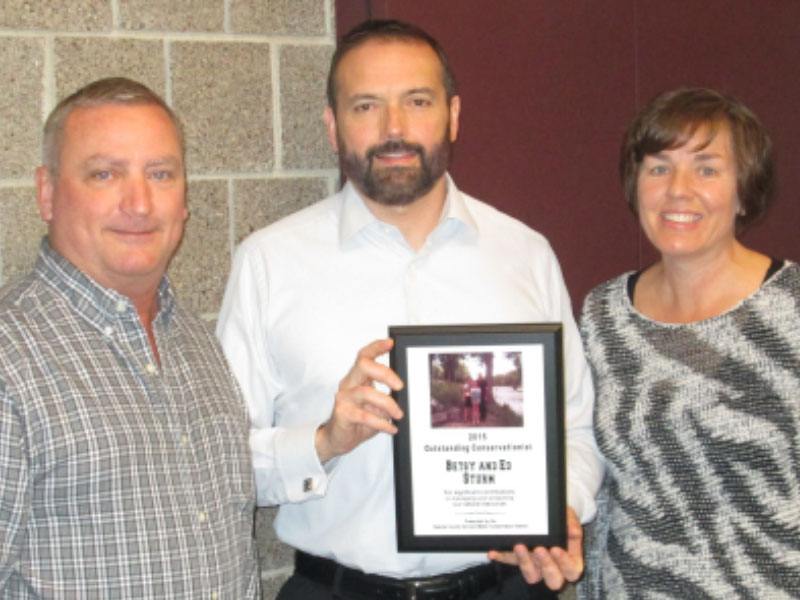 Ed and Betsy Sturm (right) accepting award from DCSWCD Board Supervisor Joe Meyers (left) 